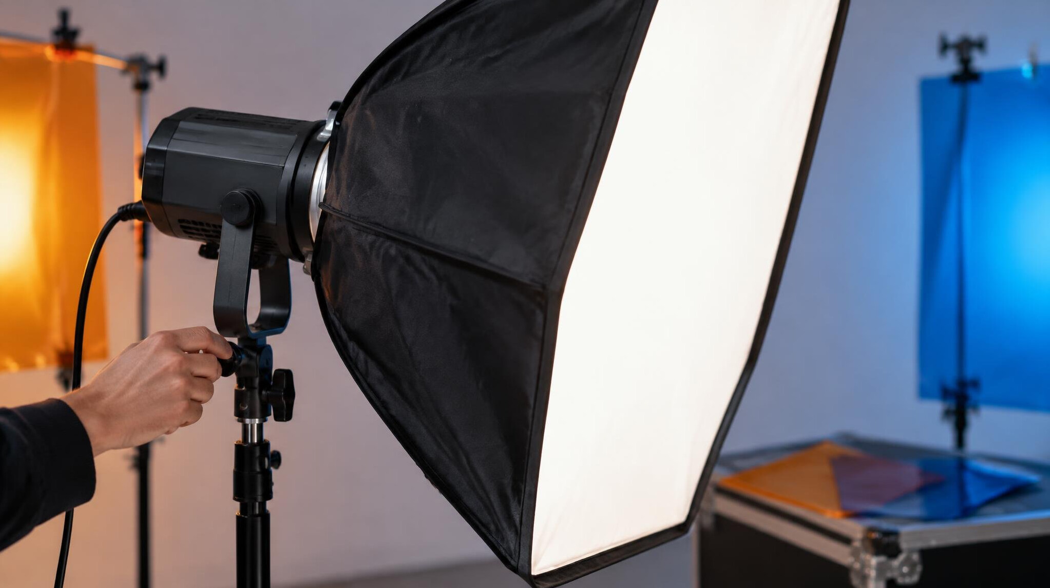 Close-up of a studio softbox light and stand being adjusted for filming